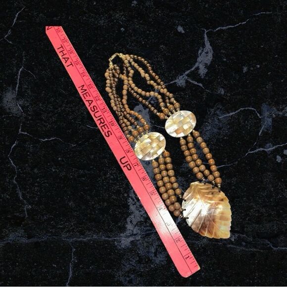 Elegant Brown Wooden Beaded Necklace with Carved Mother of Pearl Leaf Pendant - Picture 11 of 11